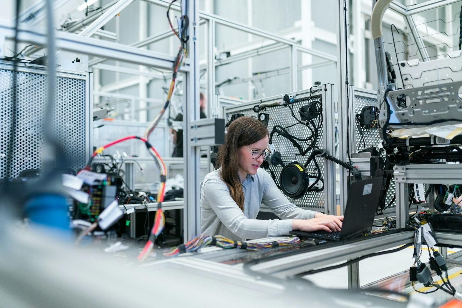 Engineer working at a laptop inside a technical facility