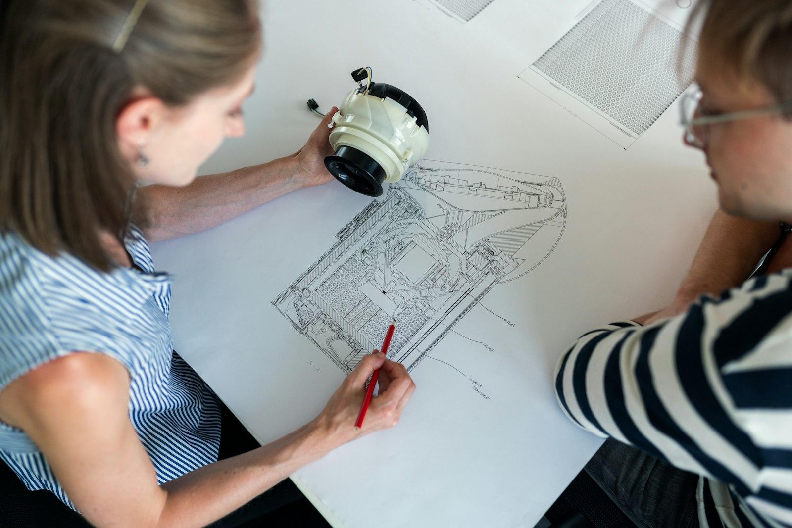 Engineers reviewing technical drawings