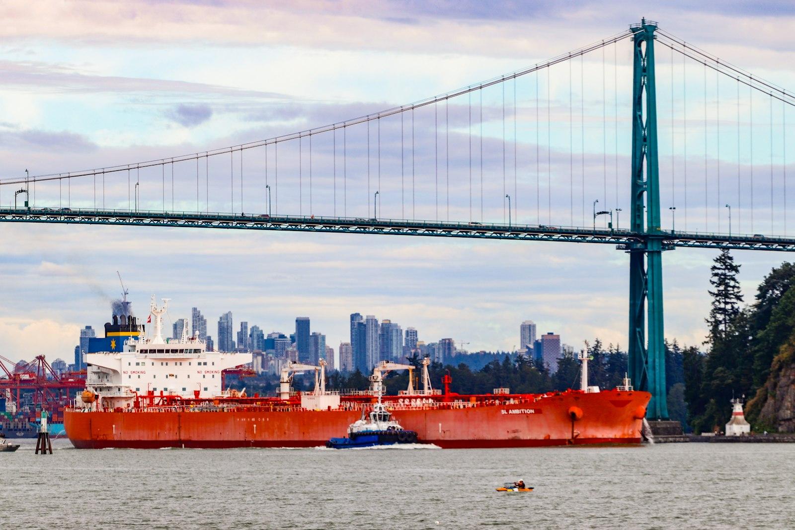 Product tankers under a bridge beside a city waterfront