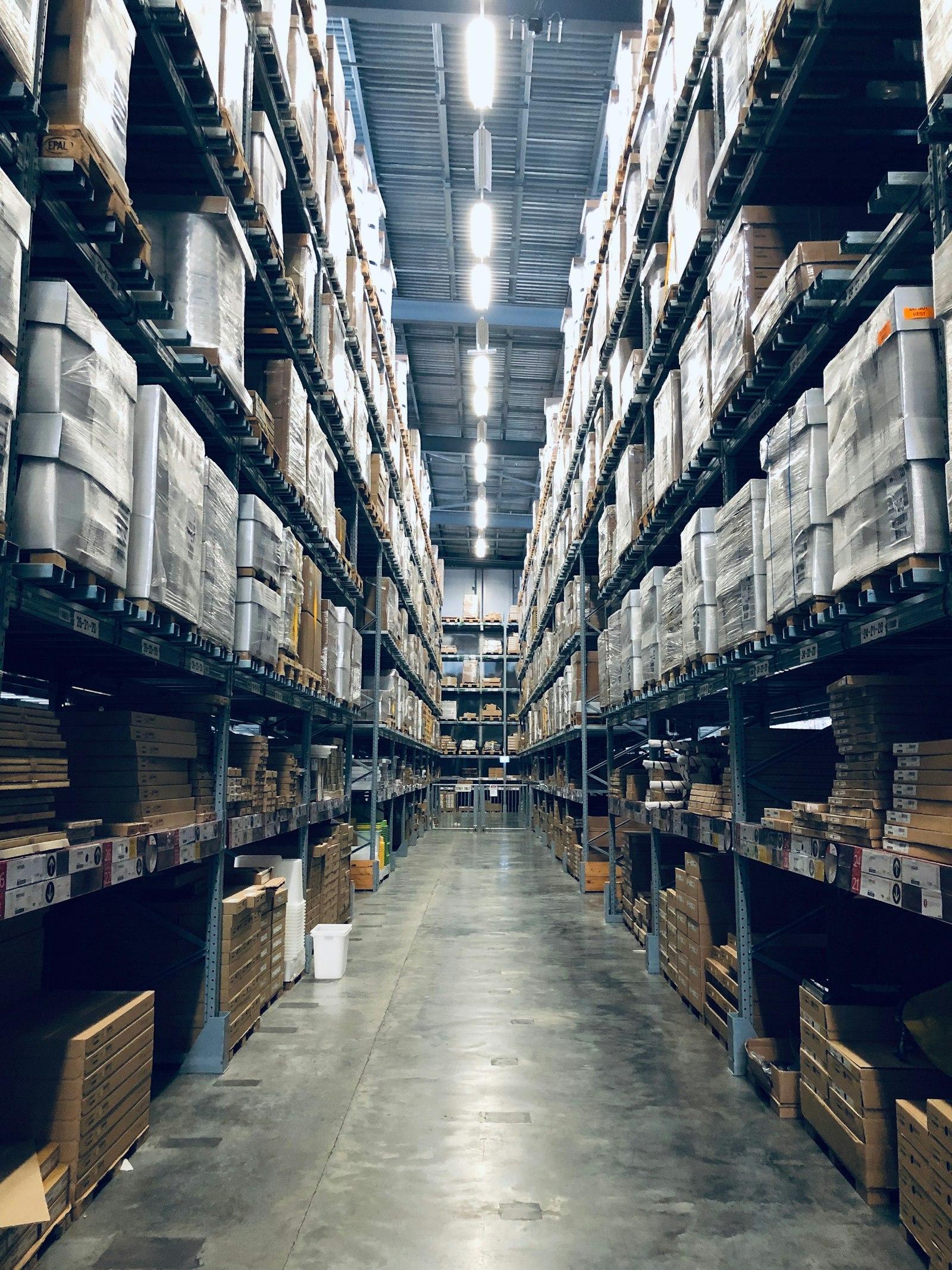 Organised industrial warehouse aisle stocked with components